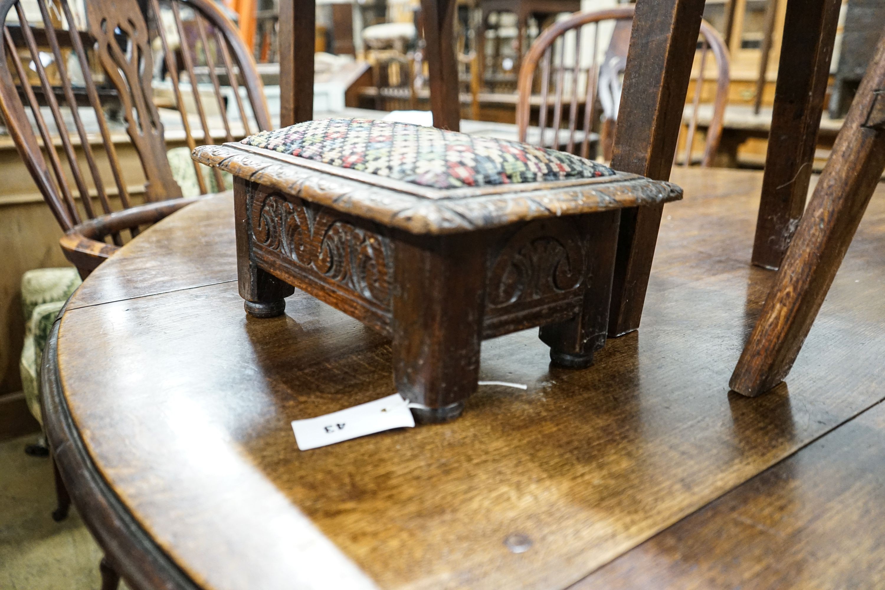 An 18th century oak low table, width 74cm, height 32cm, a carved oak foot stool and an Edwardian oak folding steps stool